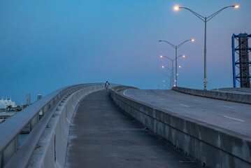 Fototapeta premium A Man crossing a Bridge in Miami - port blvd - NE 6th Street - USA - EEUU