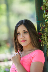  A beautiful white Latin woman posing and showing her beauty in a park near the city        