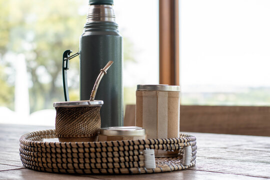 close-up of mat wood and yerba bulb and water at 80 degrees of hot temperature with thermos foam yerbera sugar bowl rustic wood base cordoba argentina