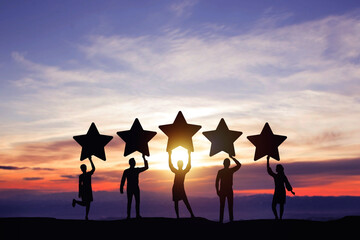 Silhouette peoples holding star with colorful dramatic sky at sunset. Service rating, satisfaction...