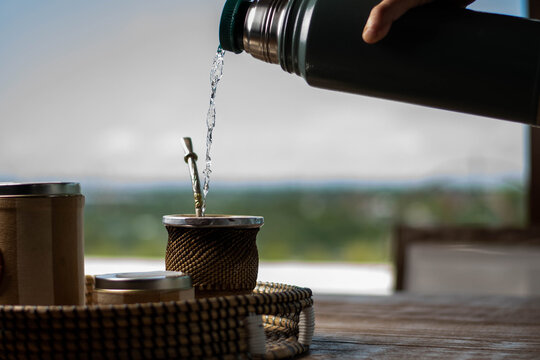 close-up of mat wood and yerba bulb and water at 80 degrees of hot temperature with thermos foam yerbera sugar bowl rustic wood base cordoba argentina