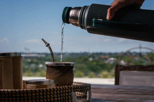 close-up of mat wood and yerba bulb and water at 80 degrees of hot temperature with thermos foam yerbera sugar bowl rustic wood base cordoba argentina