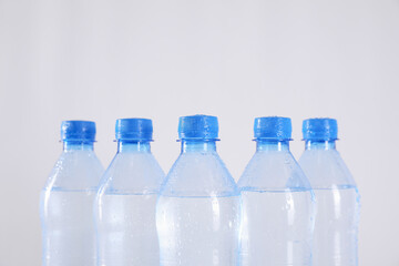 Fototapeta premium Plastic bottles with pure water on white background