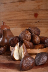 pile of salak fruit against a wooden background