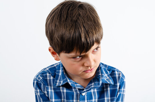 Kid in blue plaid shirt looks angry