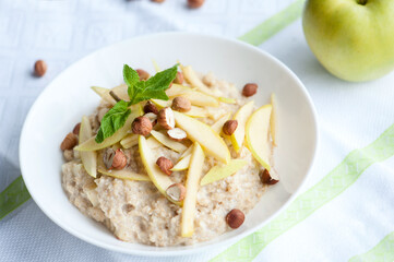 Tasty oatmeal with nuts and apples