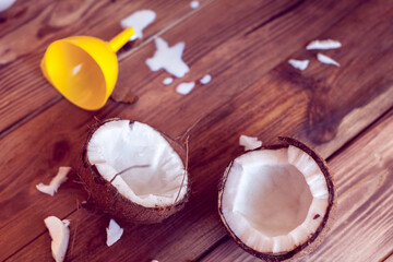 two half of coconut with yellow funnel