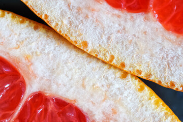 The thick skin of a cut fresh grapefruit. Unique macro.