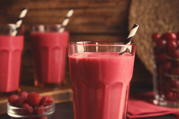 Tasty fresh milk shake with straw in glass, closeup