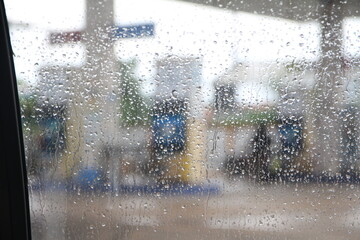 drops water with blur gas station background rain day pattern