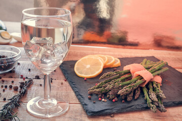 bunches of asparagus wrapped in salmon with spices and wine