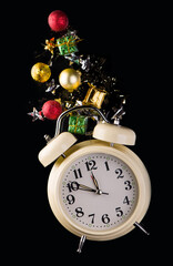 Christmas or New Year background with retro alarm clock and Christmas decorations - stars, confetti, balls and gift boxes, top view, flat lay