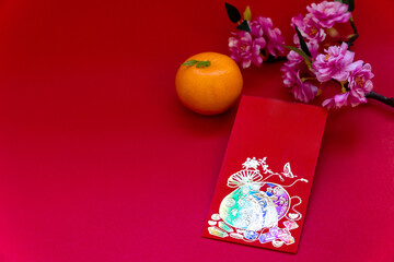 Red envelope put on red background, red envelope is gift, orange and blossom on special days such as chinese new year,
