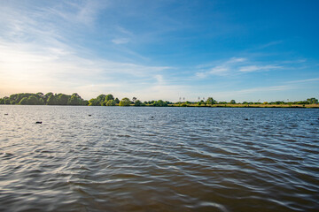 beautiful werdersee, a river in bremen, with weserstadium in the background at sunset