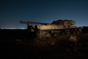 Fototapeta na wymiar Abandoned military army tank vehicle at night