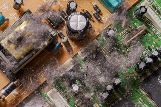 Very dusty old circuit board of electronic device illustrating concept of planned obsolescence