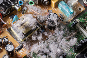 Very dusty old circuit board of electronic device illustrating concept of planned obsolescence