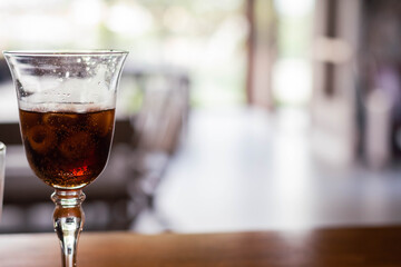 crystal glass on bar counter with bokehe bottom and ice cordoba argentina