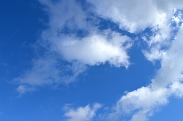 Dark blue sky with fluffy clouds, good weather background.