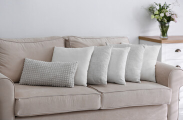 Sofa with pillows in modern living room interior