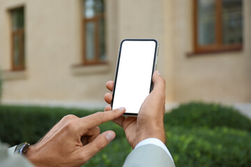 Man using modern mobile phone outdoors, closeup