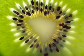 Slice of fresh juicy kiwi fruit close up macro shot for natural background.
