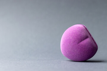 Lilac purple velvet heart ring box on a gray blurred background. Closeup view with copy space