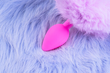 Sex toy for adult, anal plug on a violet background.