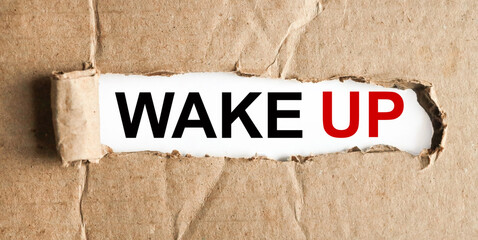 wake up, text on white paper On torn paper background