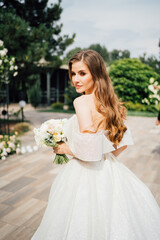 Fototapeta na wymiar bride. A beautiful woman in a white wedding dress with flowing hair