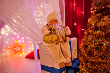 Santa claus sitting on christmas gifts