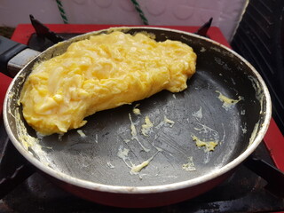 Omelette in a pan for breakfast during camping.