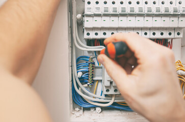 The electrician installing the electrical wiring in the house