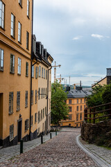 Picturesque cobblestoned street with colorful houses in Ugglan quarter in Sodermalm, Stockholm, Sweden