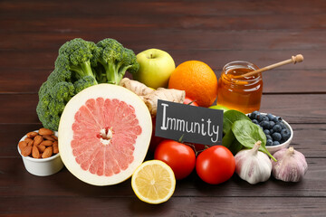 Card with word Immunity and fresh products on wooden table