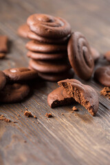 Homemade Baked Creamy Dark chocolate chip cookies on dark wooden texture background.