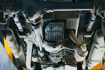 Bottom view of the car bottom. Diagnostics and repair of a vehicle in an auto repair shop. Detailed...