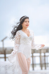 Beautiful women in white dress happily strolling at the beach, beautiful woman dressed in white bride