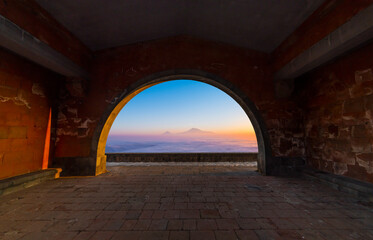 View from the arch on the sunset mountains. Beautiful arhiticture. Armenia, Garni Сharenc arch in the on the sunset.