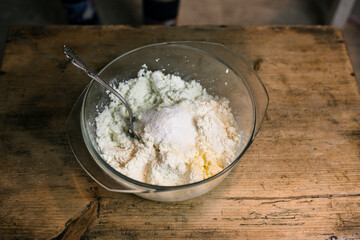 Stir the curd with a spoon in a glass bowl