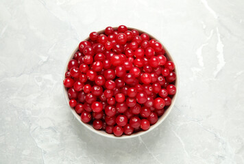 Tasty ripe cranberries on light grey marble table, top view