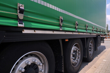 Semi-trailer with covered tarpaulin before unloading. Transport and unloading.