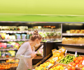  Supermarket shopping, face mask and gloves,woman buying vegetables at the market.