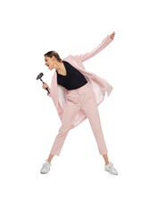Rockstar. Happy young woman dancing in casual clothes or suit, remaking legendary moves and dances...
