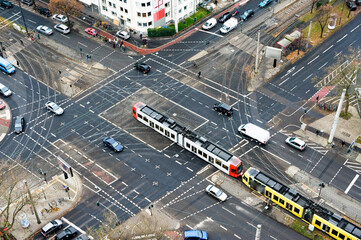 Fototapeta na wymiar A city crossing with tram and cars seen from above.