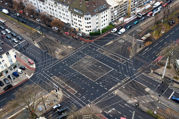 A graphic city crossing with buildings and cars seen from above.