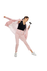 Rockstar. Happy young woman dancing in casual clothes or suit, remaking legendary moves and dances of celebrity from culture history. Isolated. Action, motion, fame concept. Creative occupation.