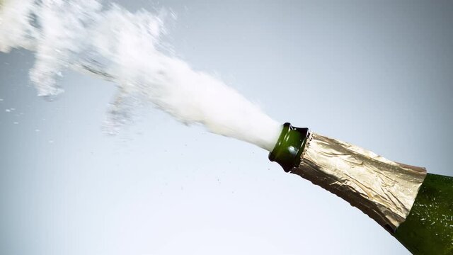 Super slow motion of Champagne explosion, opening champagne bottle closeup. Filmed on high speed cinema camera, 1000fps