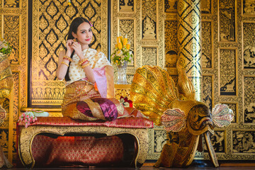 Fototapeta premium Luxury portrait of a beautiful Thai girl in traditional thai costume, identity culture of Thailand, identity culture of Asia