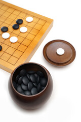 Baduk Black stone in wooden bowl